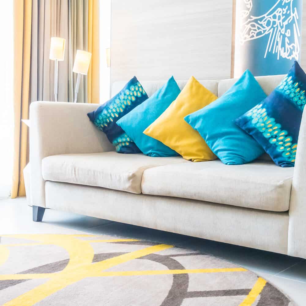 Sofa with blue cushions Seward Associates